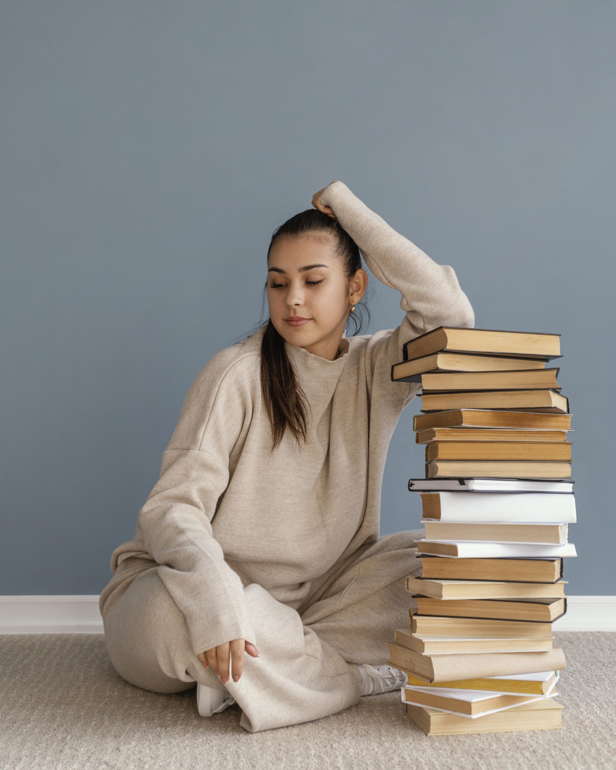 full-shot-woman-with-books-stack